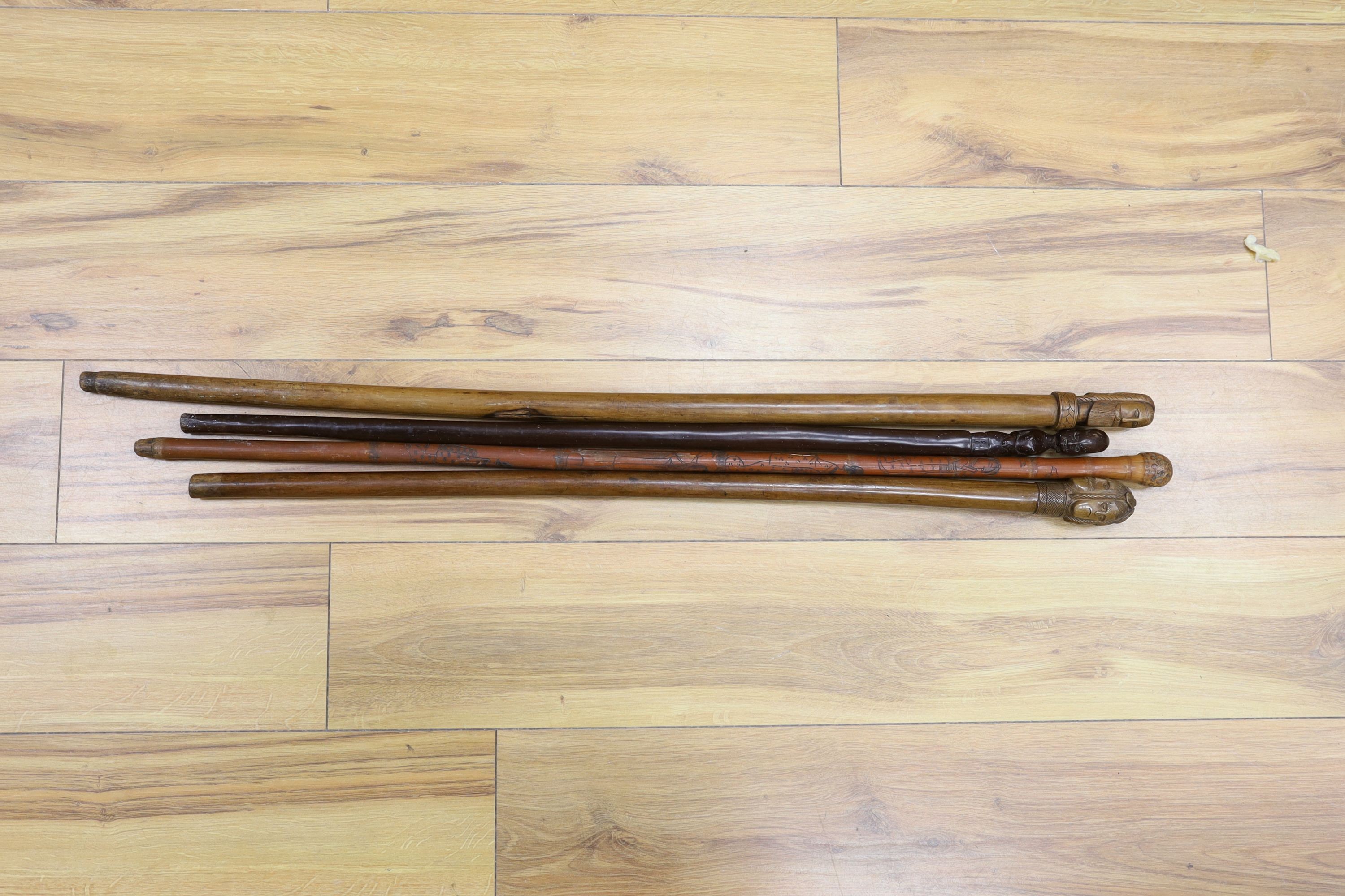 Two 19th century Greek walking sticks, a Japanese walking cane and an African cane